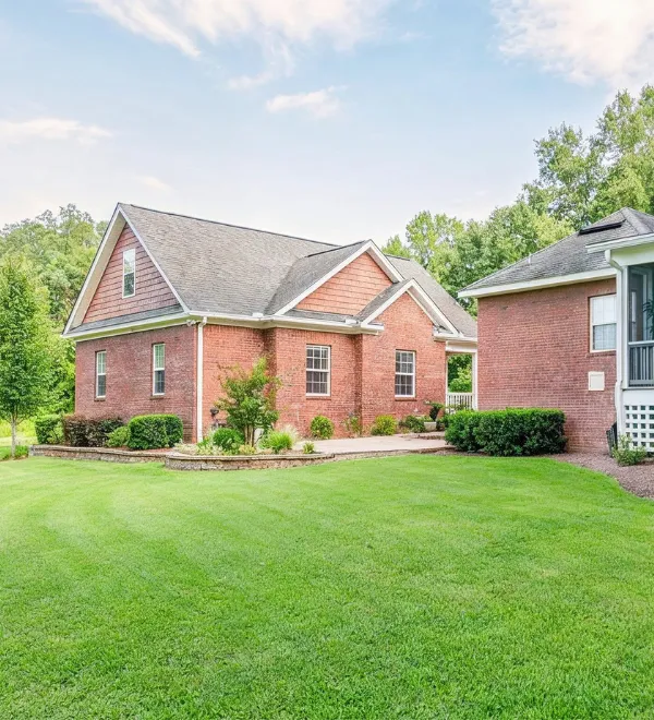 Detached ADU builders Dallas TX with brick backyard guest house designed as a private accessory dwelling unit near the main home