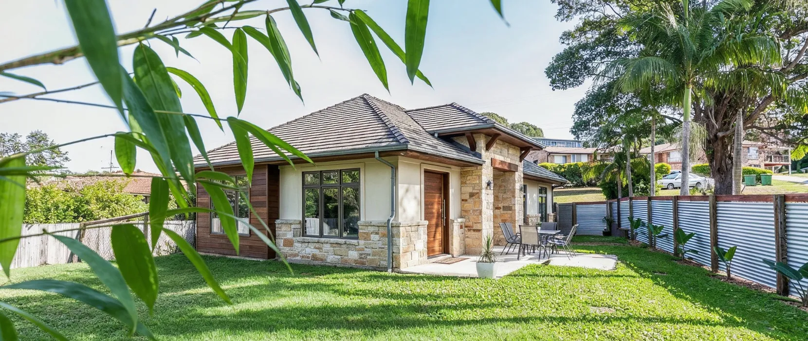 Detached ADU builders in Dallas TX creating a private backyard cottage with stone exterior patio and landscaped yard for America ADU homeowners