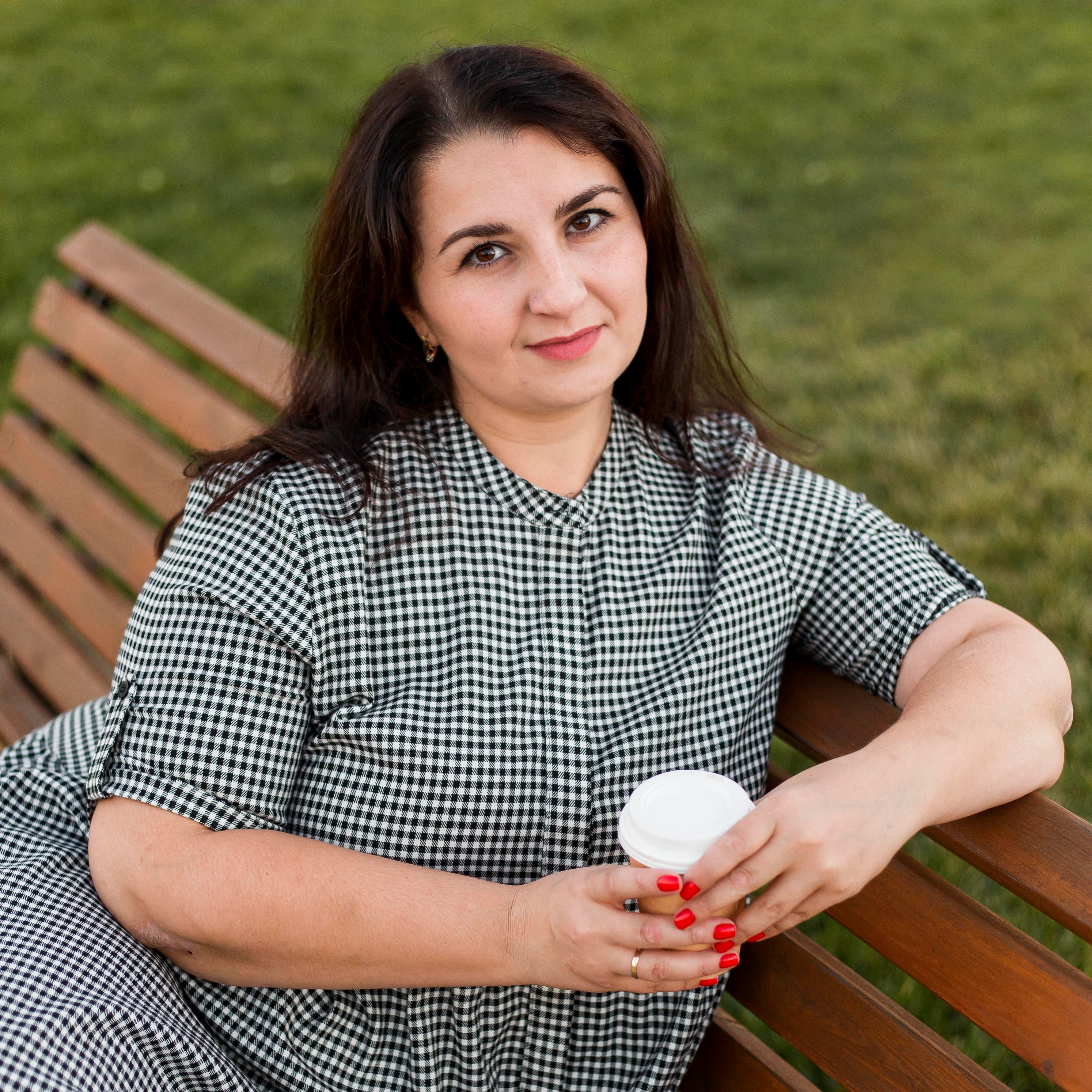 Female client sitting on park bench representing happy homeowners who trust America ADU