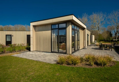 contemporary detached ADU backyard home with glass doors and patio designed by America ADU